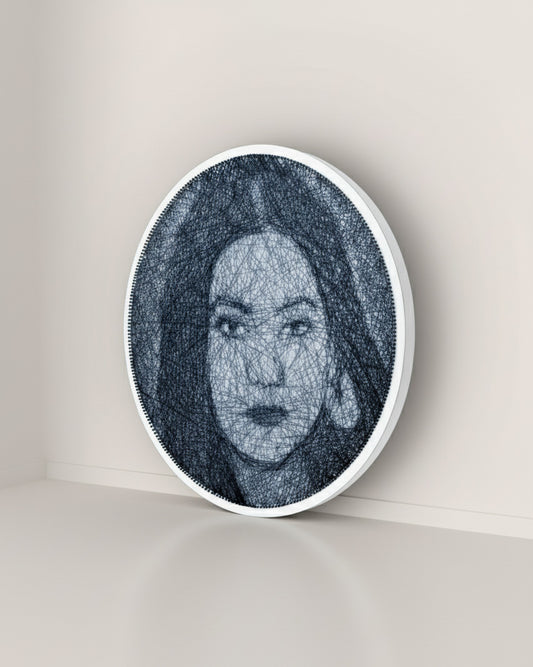 Circular wall thread nail art with a stylized portrait of a woman on a plain background